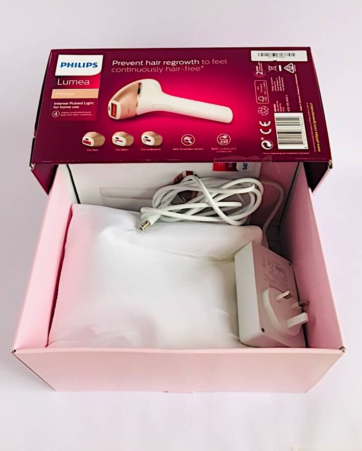 Pink Lumea packaging card board box with the power pack and cable, user manual, storage pouch with the device and treatment windows.