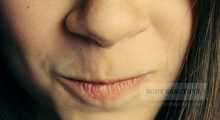 Close up photo of a young girls mouth and nose showing very fine vellus hairs.