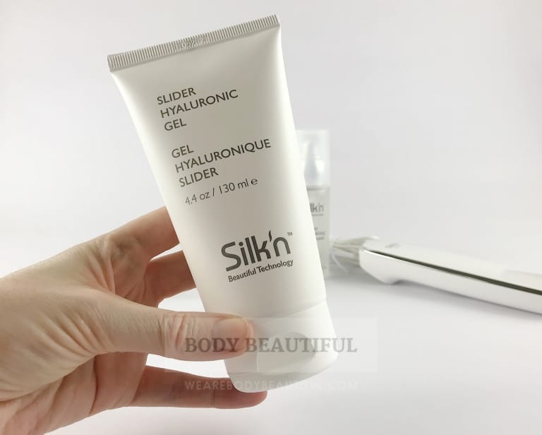 A hand holding a 130ml tube of the Silk'n FaceTite slider gel