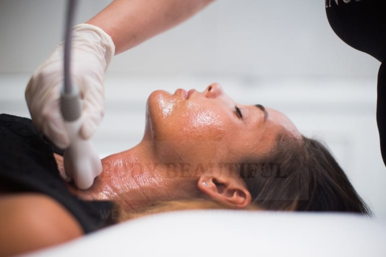Radio Frequency skin tightening probe massaging skin on a lady's neck