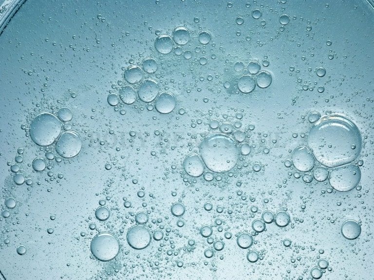 Close up of the water dissolving soluable substances. The charged particles conduct electricty