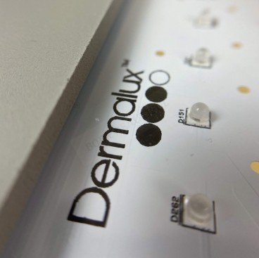 Close up photo of the Dermalux logo and LED bulbs on the Flex MD panel