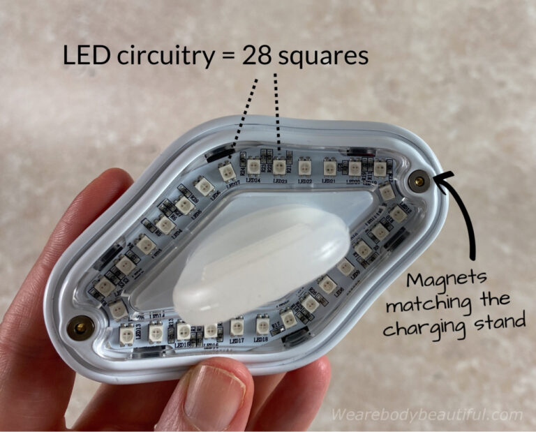 In this close-up of the Lip Perfector, you can see the 28 squares of the LED circuitry and two small circular magnets at each end matching the charging base.