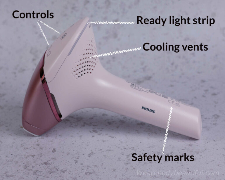 Labelled on the 9000 series device; Controls on top, a thin ‘Ready’ LED light curves around the back, and below that dotted air vents in a waved pattern. On the handle are the model data and CE / UKCA safety marks.