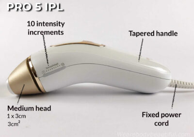 Side view of the Pro 5 IPL device showing the fixed power cord, the tapered handle, 10 intensity increments on the side power bar, and the medium flash head attached. It's 1 by 3 cm (3cm2).