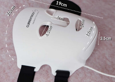 The measurements of the CurrentBody Skin Series 2 LED mask: 26cm wide (across the forehead) and 19cm high top to chin, each eye slot is 4.5cm wide corner to corner, and spaced 2.5cm apart, the nose slot if 4cm high and 3.5cm wide at the base with a covering flap, the mouth slot is 5cm wide. There’s a 12cm slit along the jaw shaped to a 3.5cm wide soft chin strap.