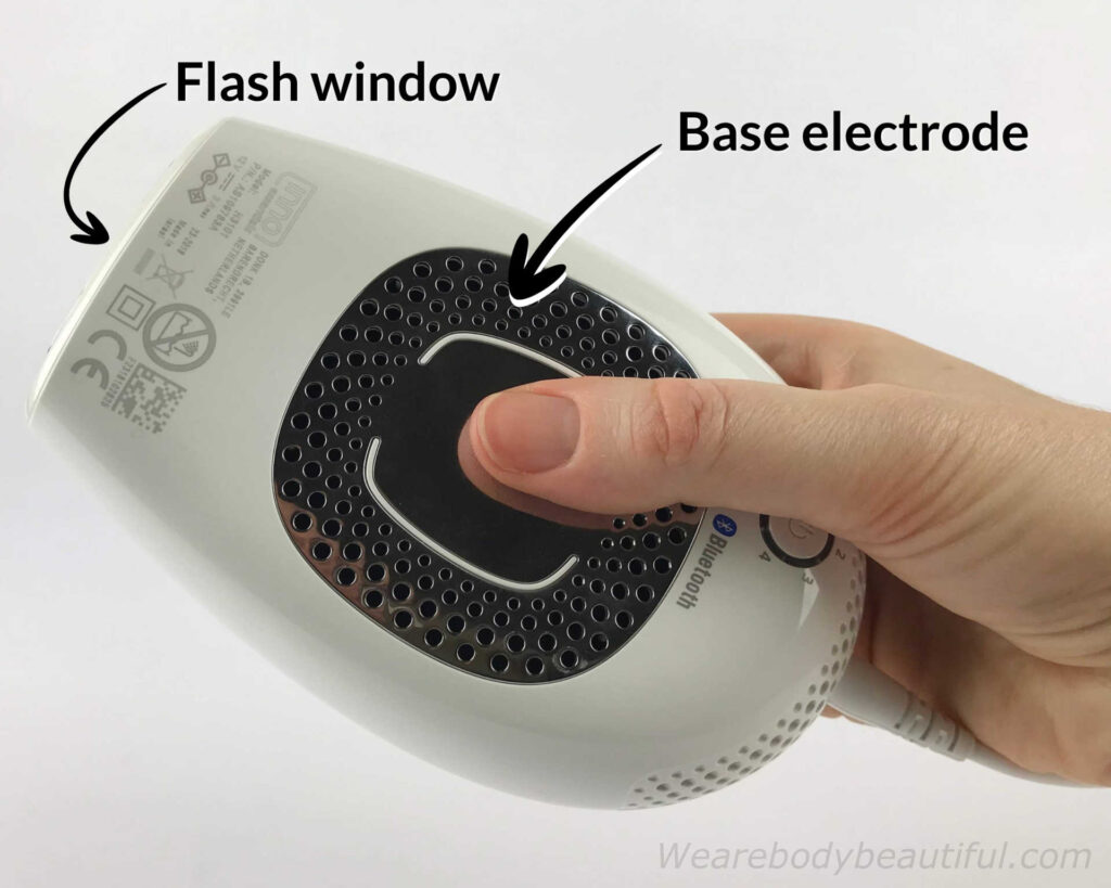 The flash window and large silver base electrode on the underside labeled on the Infinity device.